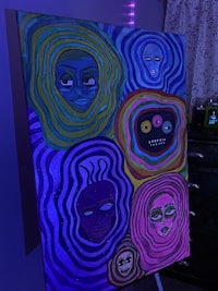 a painting on a table with colorful lights on it